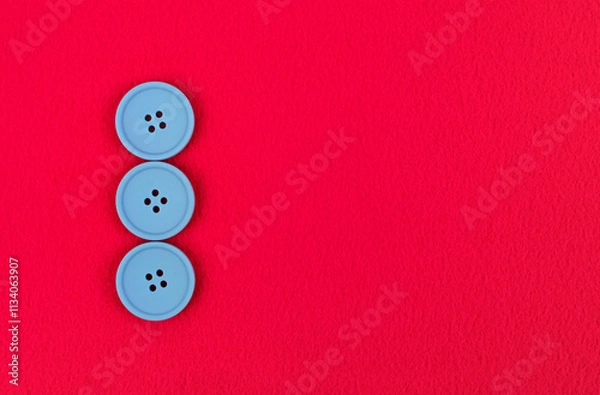 Fototapeta Three blue buttons on pink fleece fabric