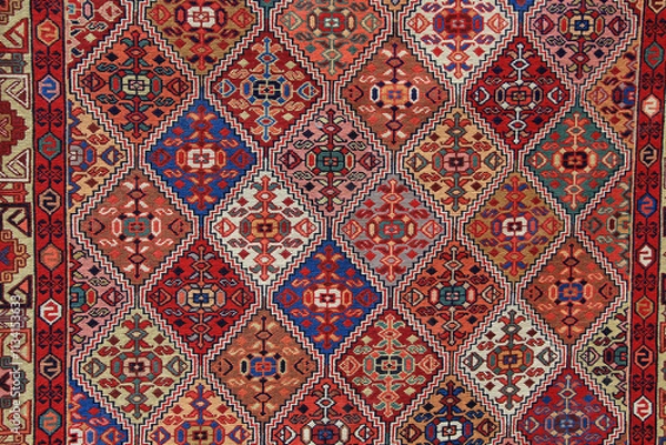Fototapeta Textures and patterns in color from woven carpets. Traditional motifs of Azerbaijani carpet and rug art.