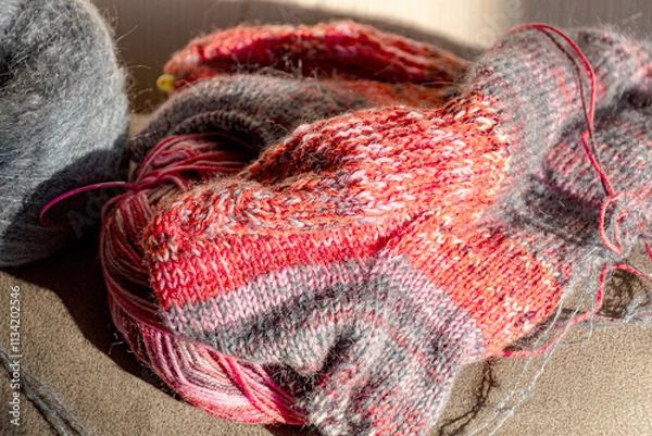 Fototapeta colorful knitted work in progress, handicraft concept, knit texture, wool handicrafts, hobby