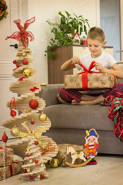Obraz child decorating christmas tree