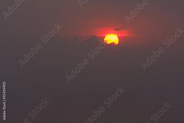 Fototapeta Gorgeous scenic of the strong sunset with silver lining and cloud on the orange sky