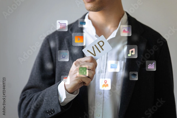 Fototapeta A man is holding a card that says VIP. The card is surrounded by icons of various apps