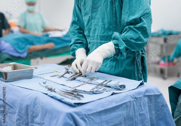 Obraz scrub nurse preparing medical instruments for operation