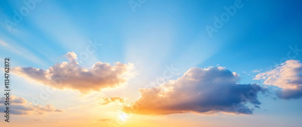 Fototapeta Serene sunrise with rays illuminating the clouds and sky.