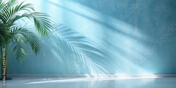 Obraz A Minimalist Interior Design with a Lush Palm Plant Casting Shadows on a Pale Blue Wall