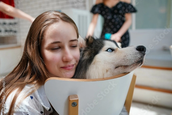 Fototapeta Woman with a Siberian Husky in the snow, enjoying a winter day together