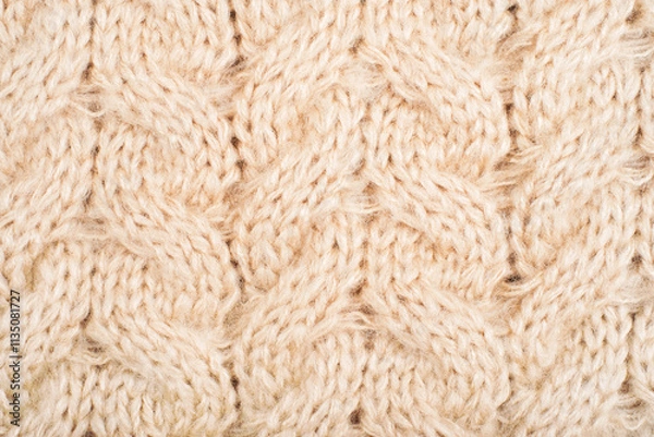Fototapeta Cozy background of beige knitted texture with cables and braids