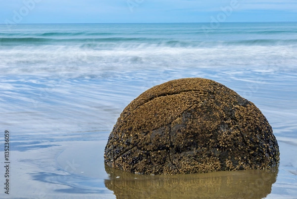 Fototapeta Long exposure shot of Moeraki Boulders in New Zealand. Famous landmark large spherical stones on Koekohe Beach near Moeraki on New Zealand's Otago coast. A popular tourist attraction