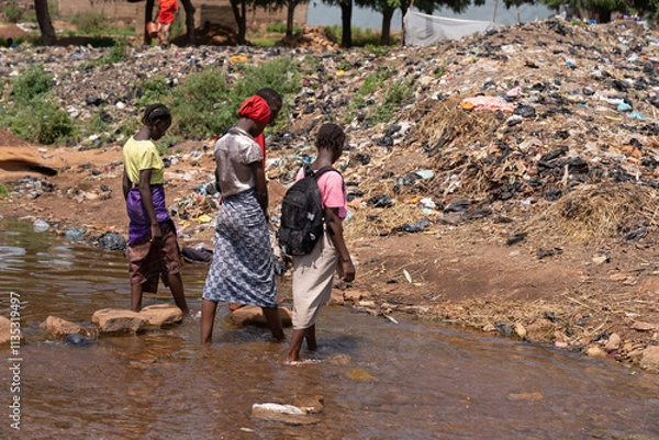 Obraz Desolate image of a group of African village children living amidst mountains of garbage due to lack of waste management