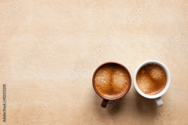 Obraz Two coffee espesso cups on brown table. Top view copy space