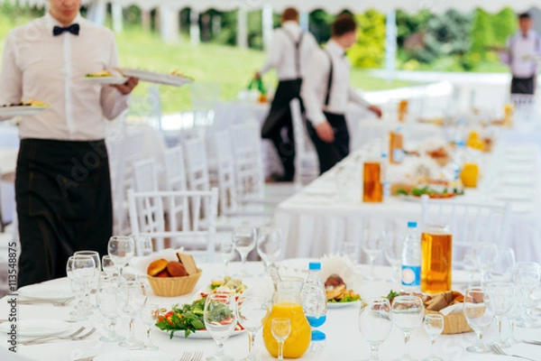 Fototapeta Catering service. Waiters at work