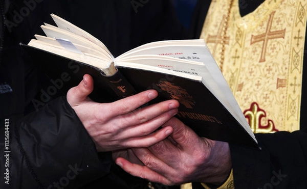 Obraz The religious book Trebnik is held in hands