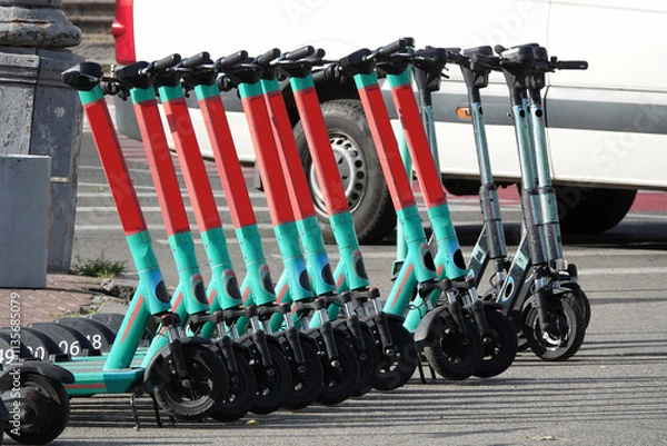 Obraz Electric scooters stand in a row