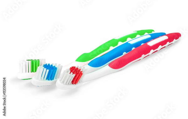 Obraz Зеленая, синяя и красная зубные щетки на изолированном белом фоне
