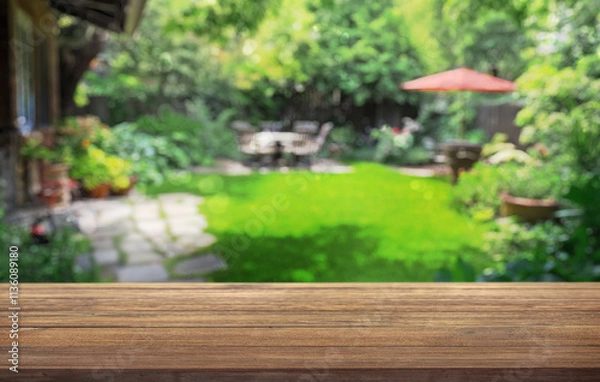 Fototapeta summer time party in backyard garden with grill BBQ, wooden table, blurred background