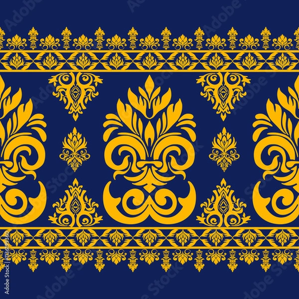 Fototapeta Elegant yellow floral pattern on deep blue background, featuring intricate designs and symmetrical motifs that create striking visual appeal