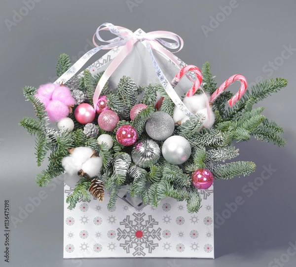Obraz A traditional Christmas floral arrangement of green fir branches and flowers. New Year's decor for the interior