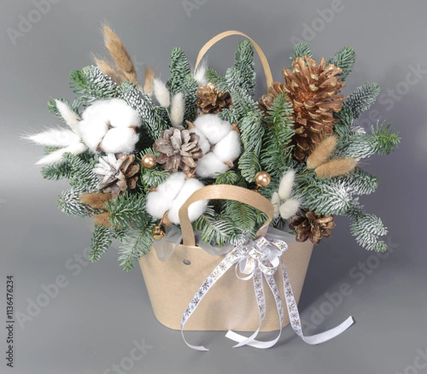 Obraz A traditional Christmas floral arrangement of green fir branches and flowers. New Year's decor for the interior