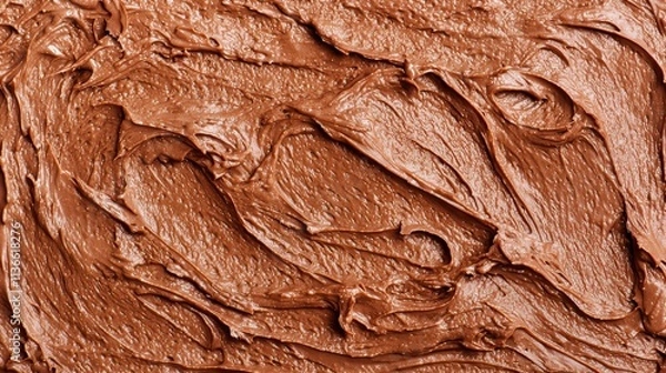 Obraz Close up of a brown frosting or chocolate spread. Concept of indulgence and richness, as the chocolate appears to be thick and creamy. The texture of the chocolate is smooth and velvety
