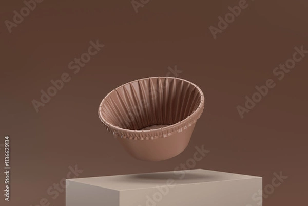 Fototapeta A brown paper cupcake is floating in the air