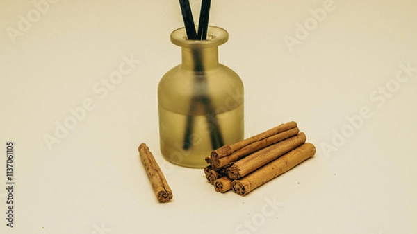 Fototapeta A beautifully arranged collection of cinnamon sticks paired gracefully with a diffuser to enhance