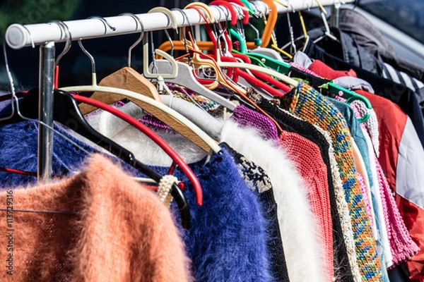 Obraz colored second hand women's sweaters at flea market