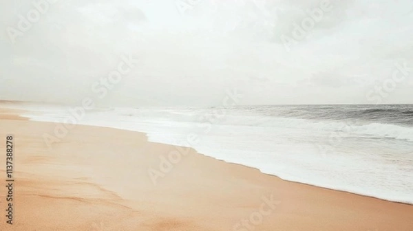 Fototapeta Serene beach scene with gentle waves and soft sand under a cloudy sky.
