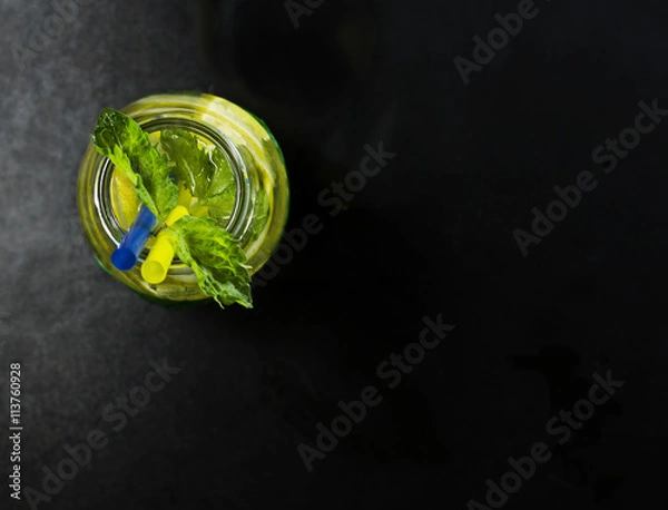 Fototapeta Cold lemonade in bottles with lemons