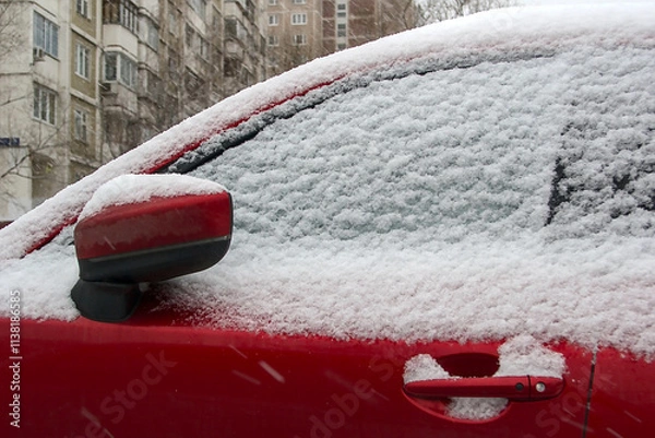 Fototapeta a snowy red car (fragment)