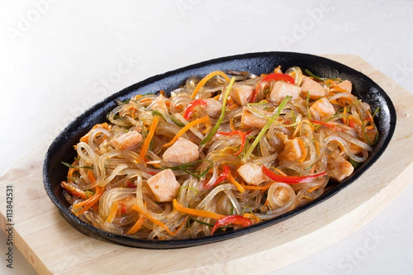 Obraz crystal noodles with vegetables chicken in a pan isolated cast iron wok