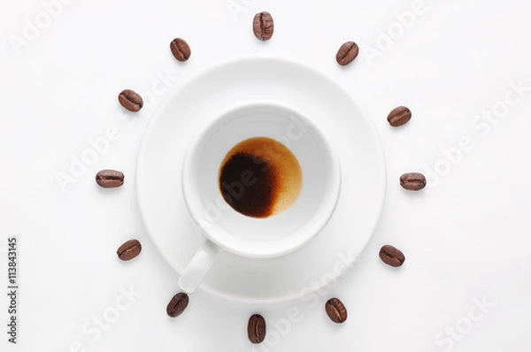 Obraz Drunk cup of coffee and coffee beans against white background forming clock dial viewed from top