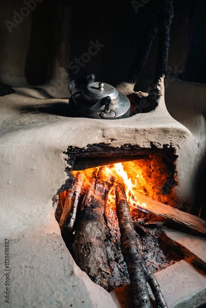 Fototapeta COOKING KETTLE ON THE WOOD FIRE IN A SHELTER IN THE MOUNTAINS OF THE HIMALAYA NEPAL
