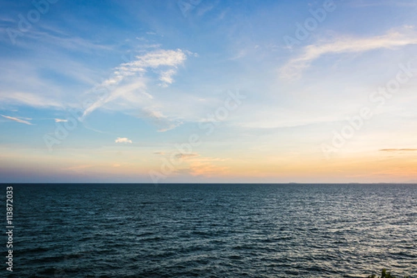 Obraz A scenery of sunset sky at the sea with partly white clouds on the blue sky at Chanthaburi Thailand.