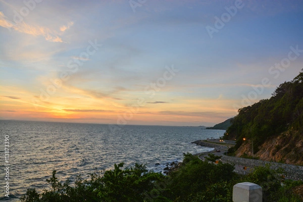 Obraz A scenery of road beside mountains and sea with the sunset time in Chanthaburi Thailand.