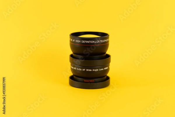 Fototapeta bunch of lenses from a professional camera in a yellow background