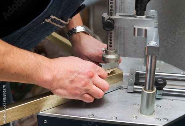 Obraz Craftsman working on frame in frameshop.