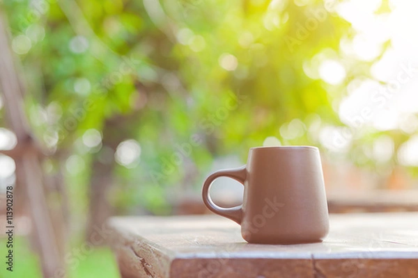 Obraz ceramic coffee cup with blur garden background