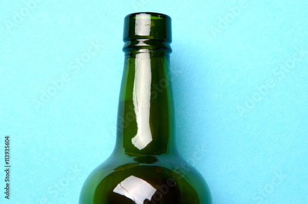 Fototapeta empty wine bottle, its upper part. blue background