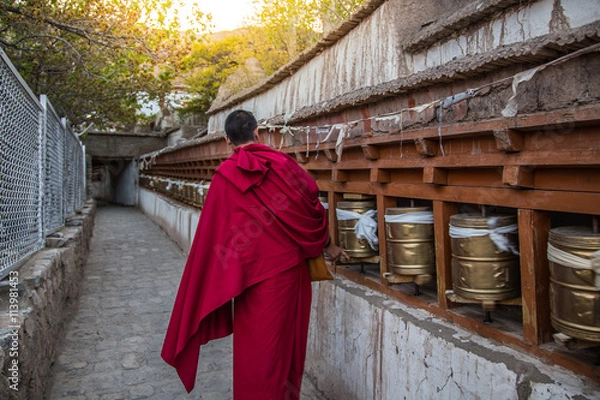 Fototapeta  Monks rotating praying wheels in thetemple