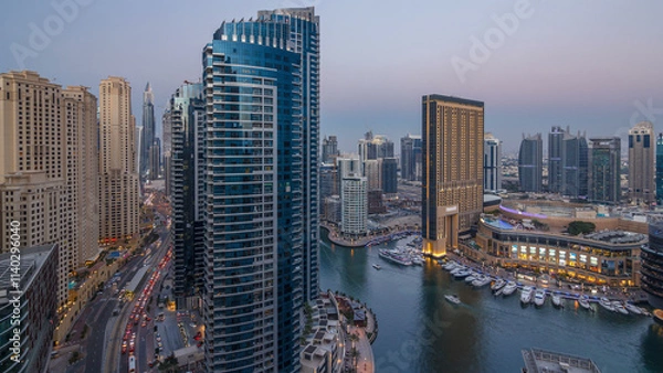 Fototapeta Evening illumination of Dubai Marina day to night aerial timelapse, UAE.