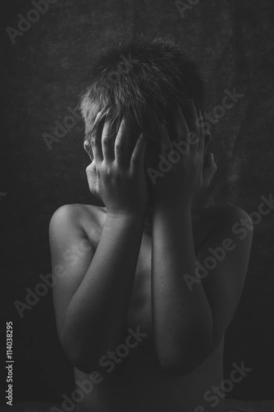 Fototapeta scared and alone, young Asian child who is at high risk of being bullied, trafficked and abused, selective focus