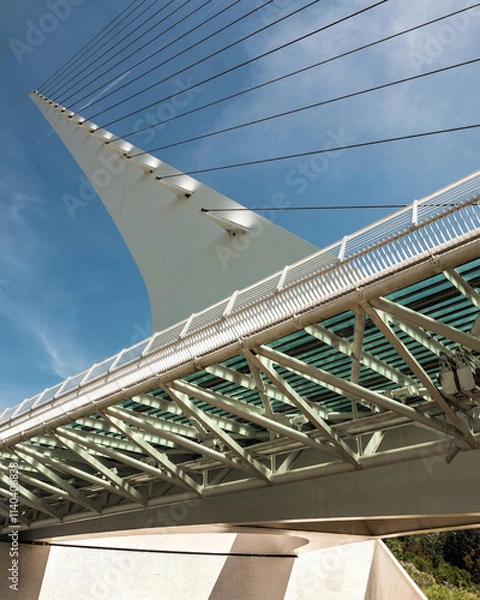 Fototapeta Stunning close-up of the Sundial Bridge's intricate steel cables and modern architectural design, set against a vibrant blue sky in Redding, California