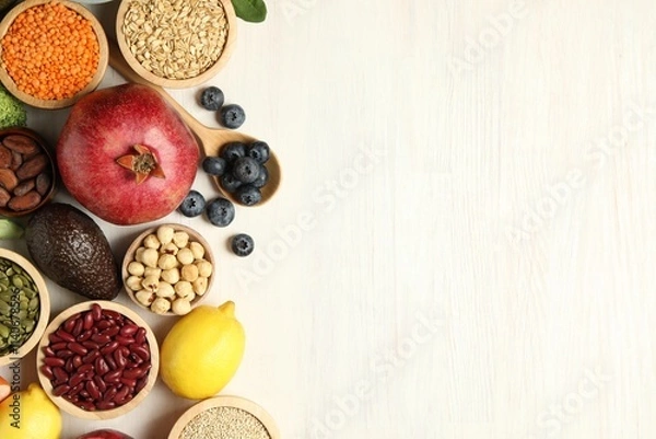 Fototapeta Different superfood products on white table, flat lay. Space for text