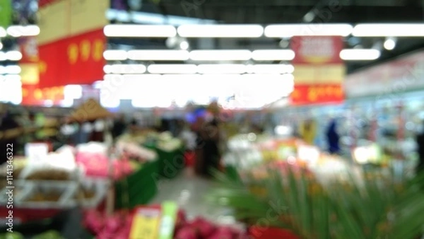 Obraz blurry photo of a white-floored supermarket with shelves selling goods in the background