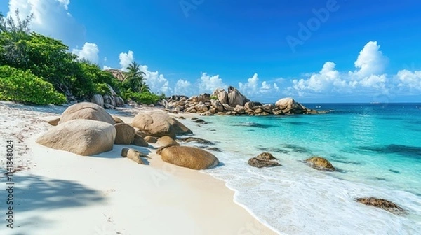 Obraz Pristine white sand beach with turquoise waters and smooth stones under a clear blue sky