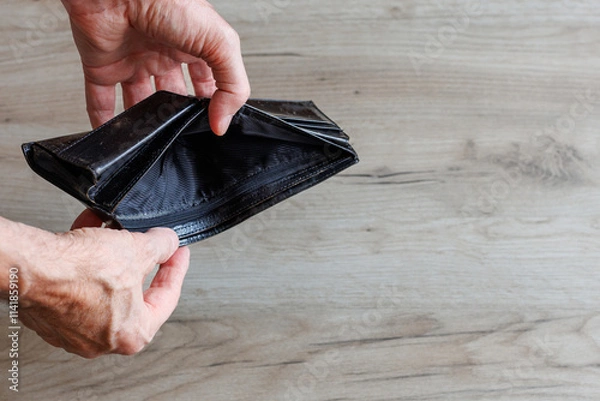 Fototapeta Empty wallet in hands of man. Financial crisis and poverty concept.