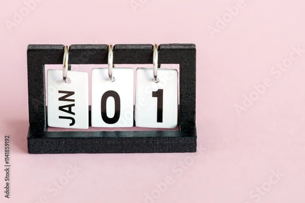 Fototapeta Desktop calendar on a pink background. The first day of the new year. January 1st.