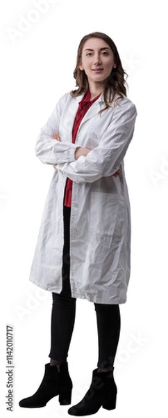 Fototapeta Young confident female technician wearing a lab coat poses with crossed arms on transparent  looking directly at the camera with a serious, determined expression