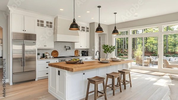 Fototapeta A kitchen with a wooden island and a large window. The kitchen is clean and well-lit, with a modern design. Scene is warm and inviting