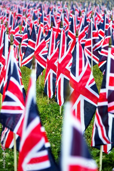 Fototapeta British United Kingdom UK Flags in a row with front focus and the further away symbols blurry with bokeh. The flags were set up on Memorial Day in DC.